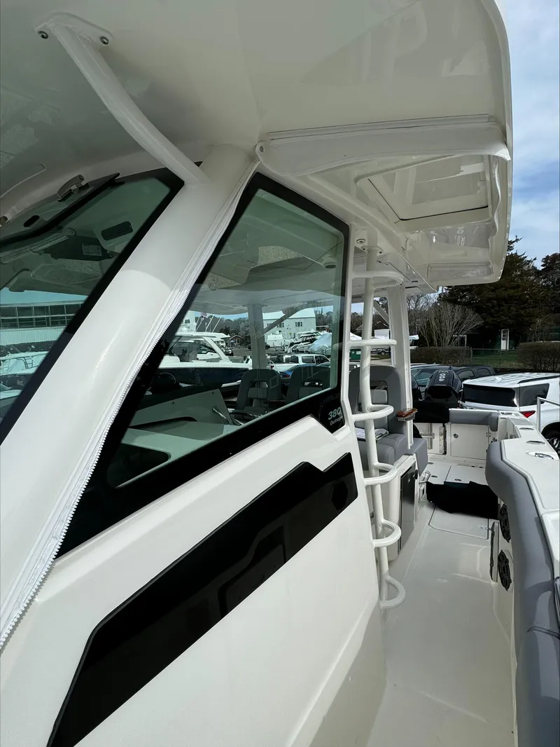 Slide: The Image of 2025 Boston Whaler 380 Outrage boat, side view with sleek design and spacious deck. - 32
