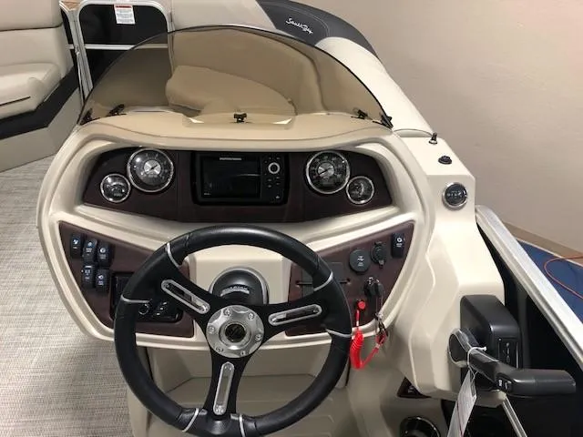 Slide: The Image of 2023 South Bay 224RS LE 2.75 boat dashboard with steering wheel and control panel. - 4