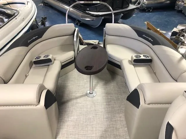 Slide: The Image of 2023 South Bay 224RS LE 2.75 boat interior with beige seating and central table. - 5