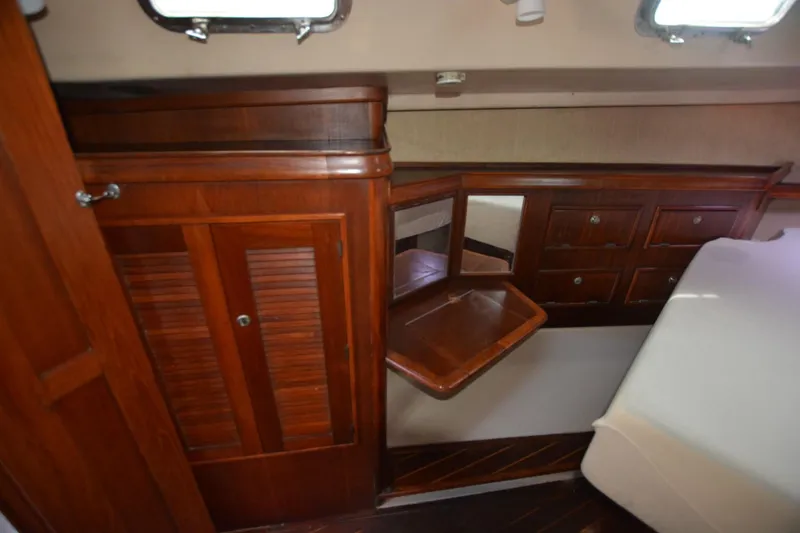 Slide: The Image of Interior of 1994 Island Packet 44 sailboat with wooden cabinetry and fold-out table. - 13
