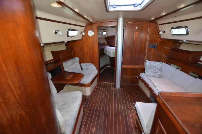 Slide: The Image of Interior of 1994 Island Packet 44 sailboat with wooden furnishings and cozy seating. - 15