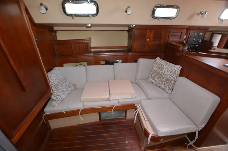 Slide: The Image of Interior of 1994 Island Packet 44 yacht with cushioned seating and wooden accents. - 16