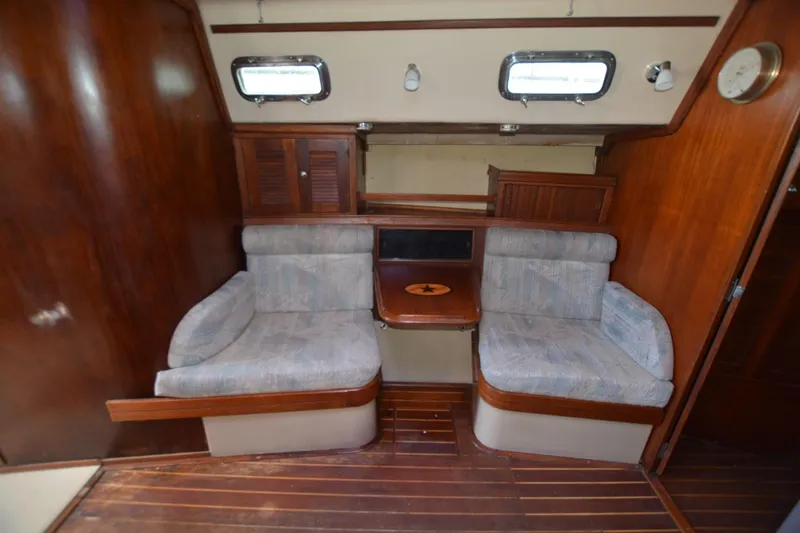 Slide: The Image of Interior of 1994 Island Packet 44 sailboat with wooden finish and cushioned seating. - 17