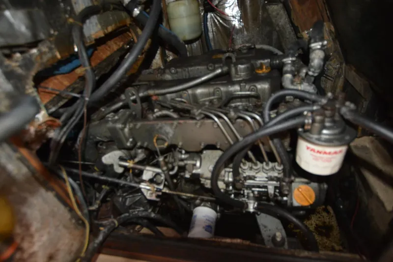Slide: The Image of Engine compartment of a 1994 Island Packet 44 sailboat, featuring Yanmar components. - 24