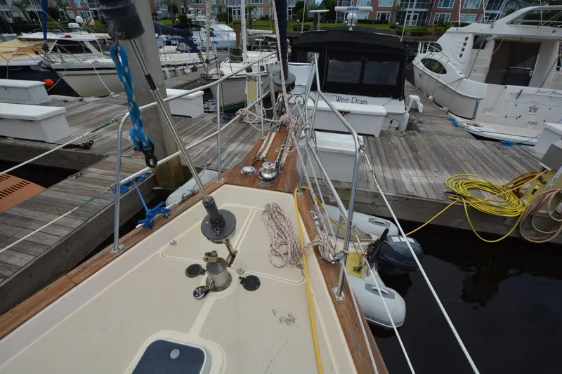 Slide: The Image of 1994 Island Packet 44 sailboat docked at marina, showcasing deck and rigging details. - 3