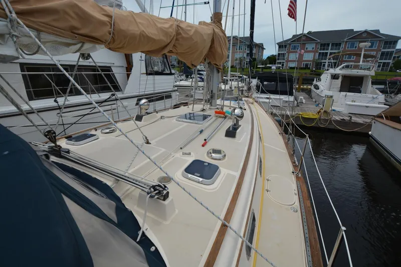 Slide: The Image of Sailboat Island Packet 44, 1994 model, docked at marina with residential buildings in background. - 5