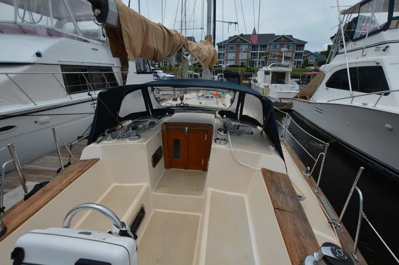 Slide: The Image of 1994 Island Packet 44 sailboat docked, featuring spacious cockpit and classic design. - 6