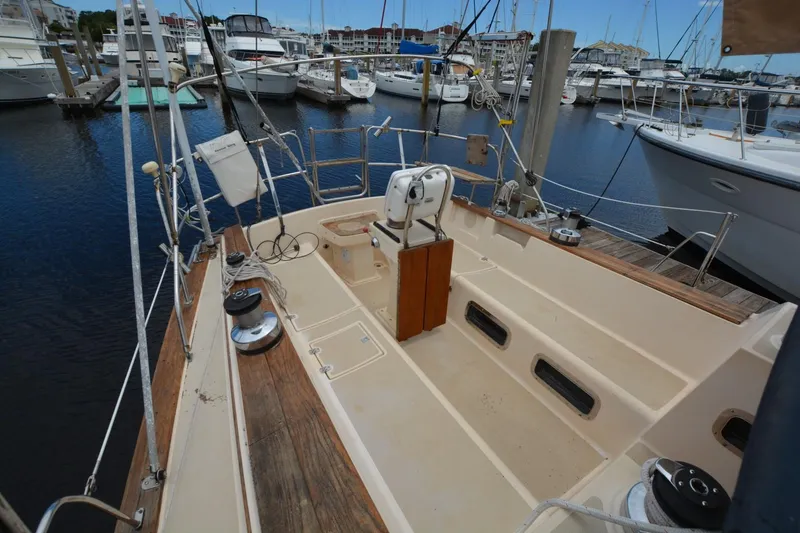 Slide: The Image of Sailboat cockpit of 1994 Island Packet 44 docked in marina, featuring wooden and metal details. - 7