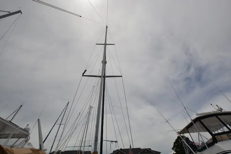 Slide: The Image of Sailboat masts against cloudy sky, Island Packet 44, 1994 model. - 9