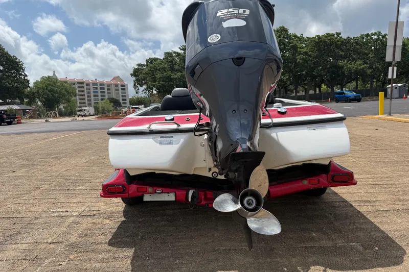 Slide: The Image of 2011 Skeeter FX 21 boat with 250 HP engine in a parking lot. - 10