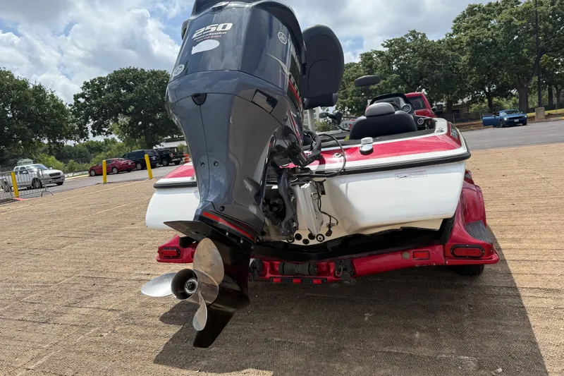 Slide: The Image of 2011 Skeeter FX 21 boat with powerful outboard motor, parked on a sunny day. - 11