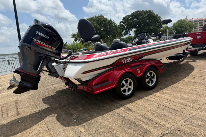 Slide: The Image of 2011 Skeeter FX 21 boat with Yamaha engine on a trailer, parked outdoors. - 13