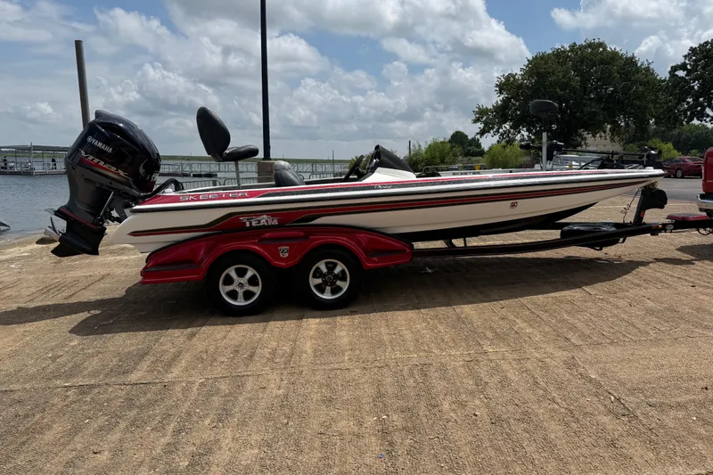 Slide: The Image of 2011 Skeeter FX 21 boat with Yamaha engine on a trailer by the water. - 15