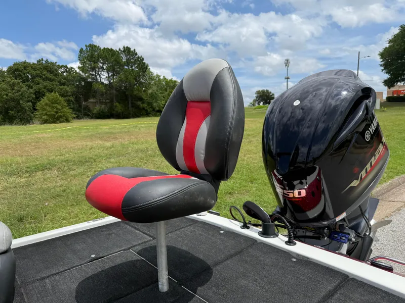 Slide: The Image of 2011 Skeeter FX 21 boat seat and Yamaha motor on grassy landscape. - 26