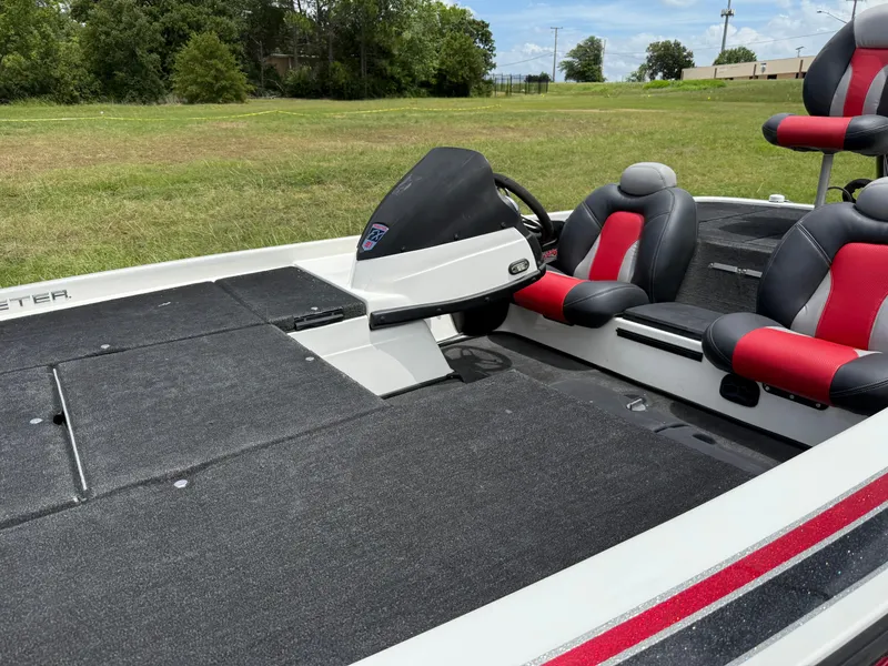 Slide: The Image of 2011 Skeeter FX 21 boat interior with red and black seats, steering console, and spacious deck. - 28