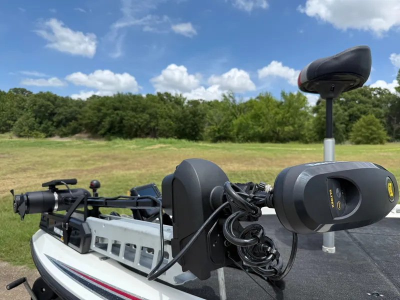 Slide: The Image of 2011 Skeeter FX 21 boat with trolling motor, set against a scenic outdoor backdrop. - 30
