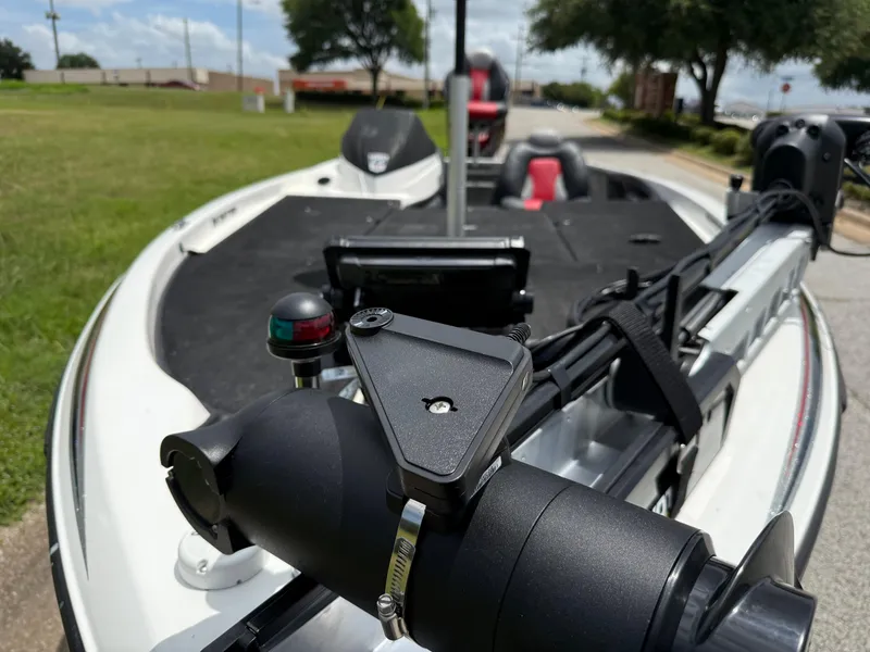 Slide: The Image of 2011 Skeeter FX 21 boat with trolling motor and navigation light, parked on roadside. - 32