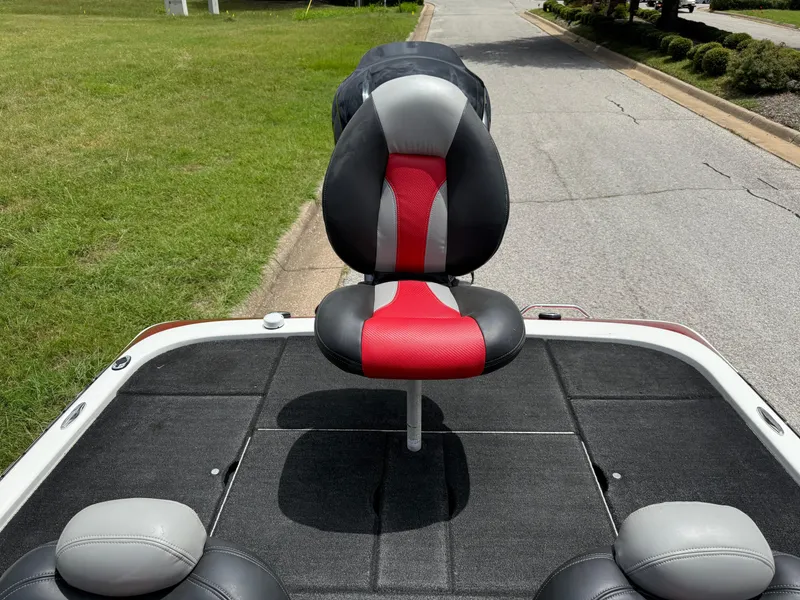 Slide: The Image of 2011 Skeeter FX 21 boat seat with red and black design on a sunny day. - 34