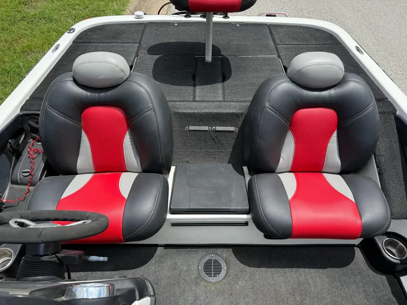 Slide: The Image of 2011 Skeeter FX 21 boat interior with red and gray seats, steering wheel visible. - 35