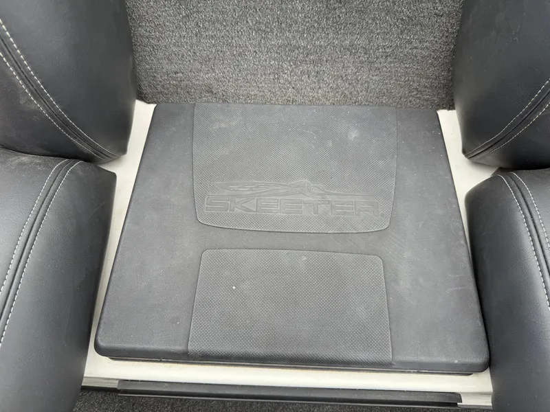Slide: The Image of 2011 Skeeter FX 21 boat interior with branded floor mat between seats. - 36