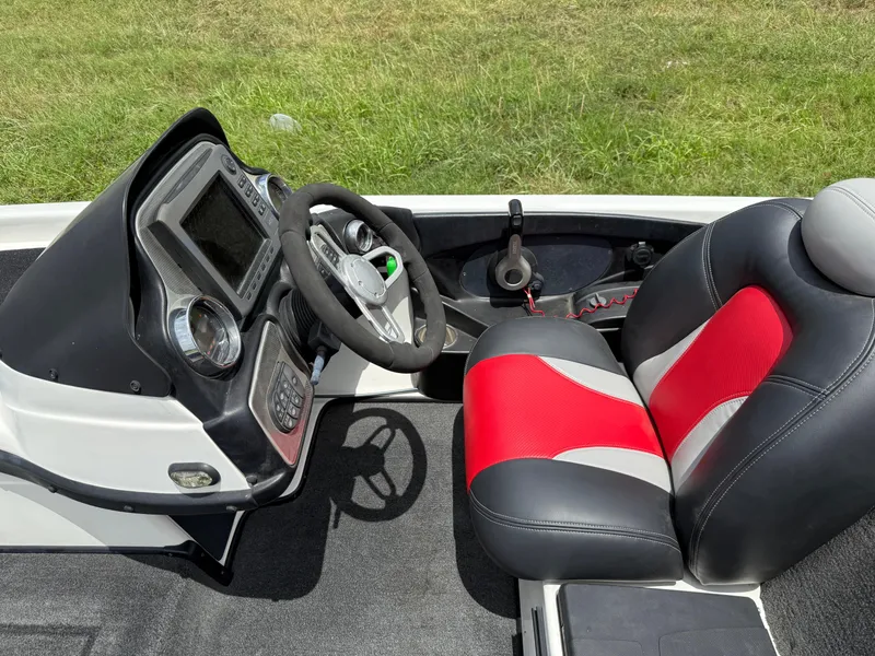 Slide: The Image of 2011 Skeeter FX 21 boat cockpit with steering wheel and red-black seat. - 37