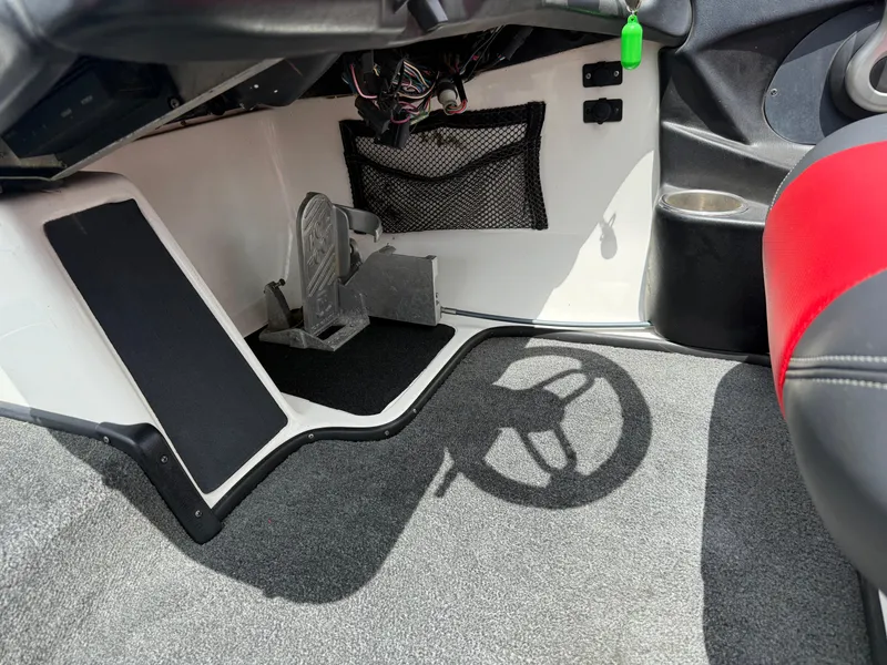 Slide: The Image of 2011 Skeeter FX 21 boat interior with foot pedal and steering wheel shadow. - 38