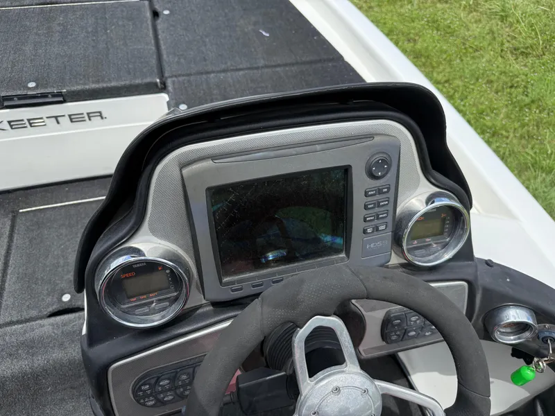 Slide: The Image of 2011 Skeeter FX 21 boat dashboard with steering wheel and electronic display. - 39
