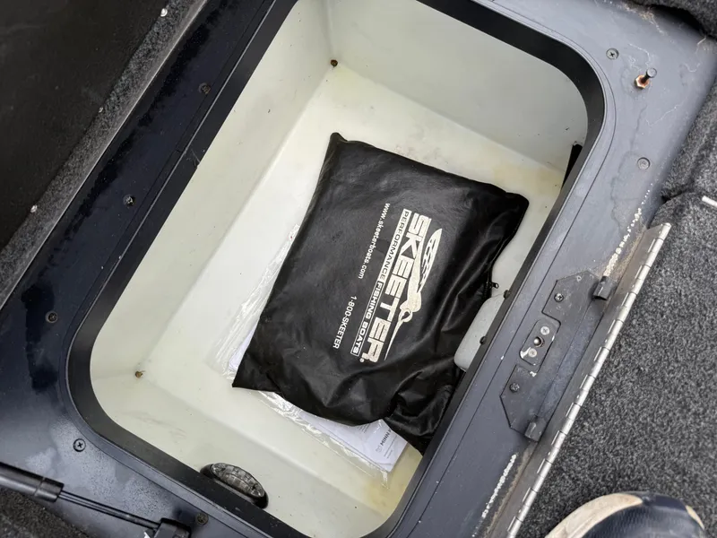 Slide: The Image of Storage compartment of a 2011 Skeeter FX 21 boat with branded bag inside. - 40