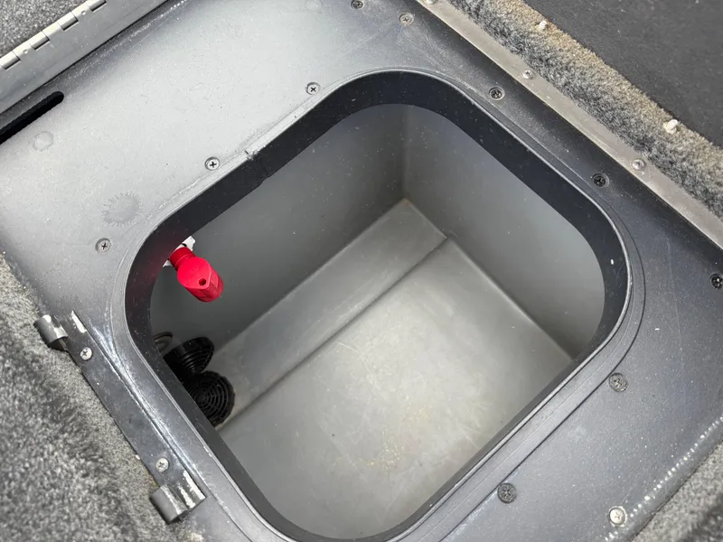 Slide: The Image of 2011 Skeeter FX 21 boat storage compartment with red valve, open and empty. - 43