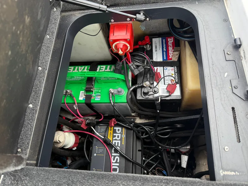 Slide: The Image of 2011 Skeeter FX 21 boat battery compartment with multiple batteries and wiring. - 45