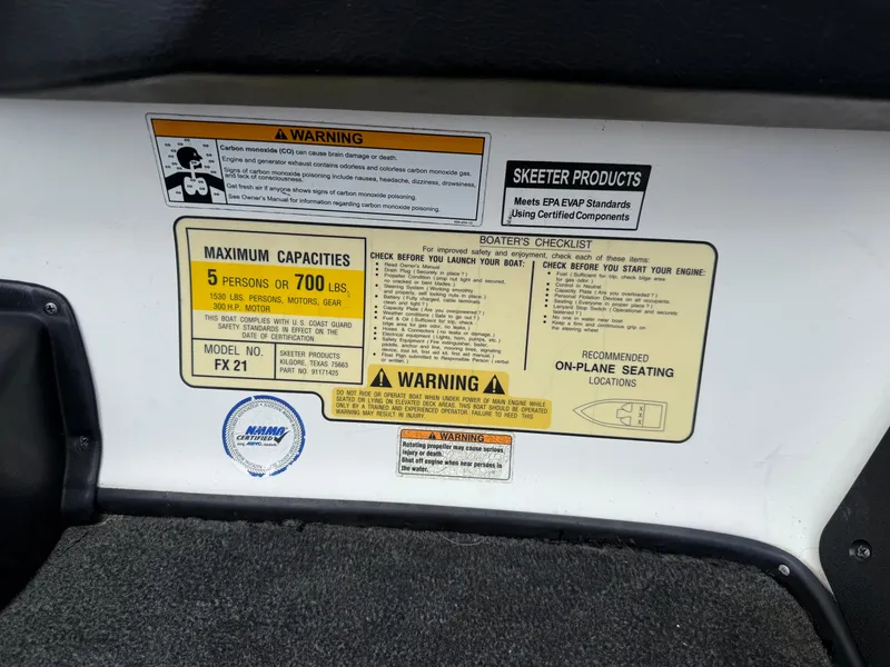 Slide: The Image of 2011 Skeeter FX 21 warning labels and capacity information on boat interior. - 47