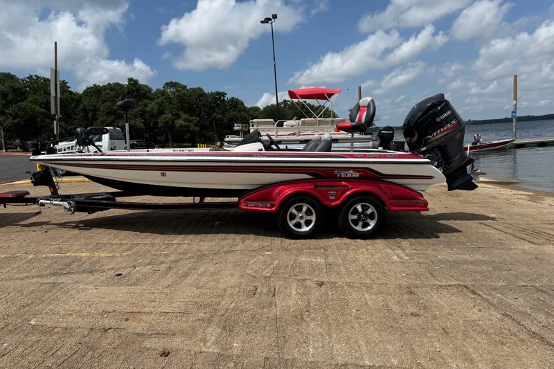 Slide: The Image of 2011 Skeeter FX 21 boat on trailer by a lake under a cloudy sky. - 5