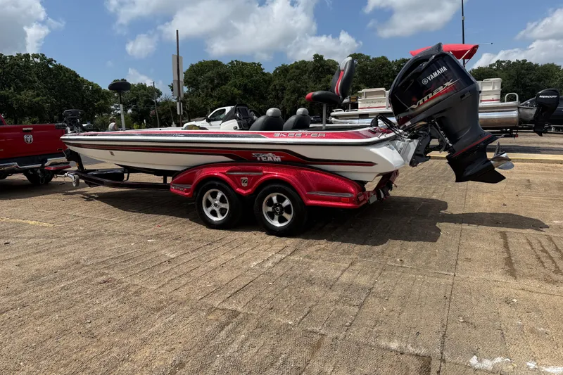 Slide: The Image of 2011 Skeeter FX 21 bass boat with Yamaha engine on a red trailer. - 7