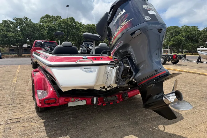 Slide: The Image of 2011 Skeeter FX 21 boat with Yamaha engine on a trailer in a parking lot. - 9