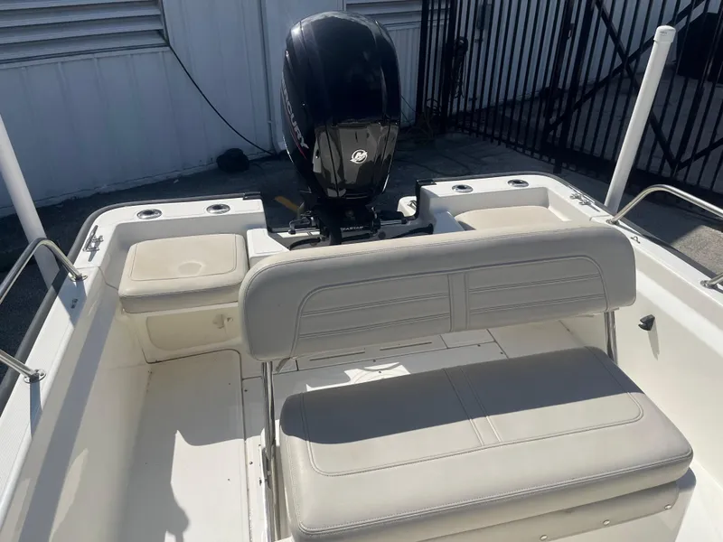 Slide: The Image of 2022 Boston Whaler 170 Montauk boat interior with seating and Mercury outboard motor. - 11