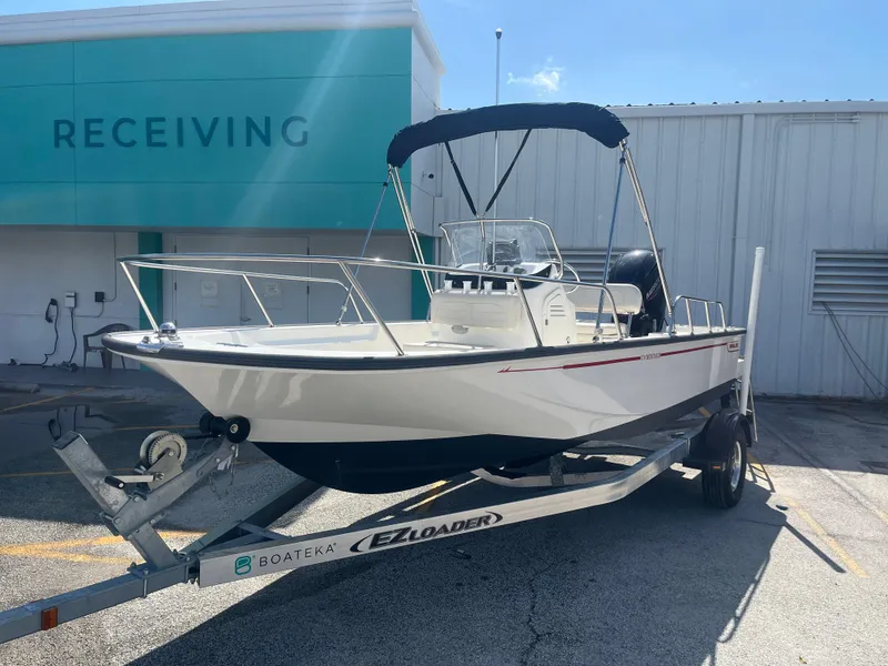 Slide: The Image of 2022 Boston Whaler 170 Montauk boat on trailer outside receiving area. - 2