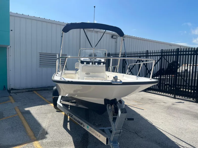 Slide: The Image of 2022 Boston Whaler 170 Montauk boat on trailer, parked outdoors. - 3