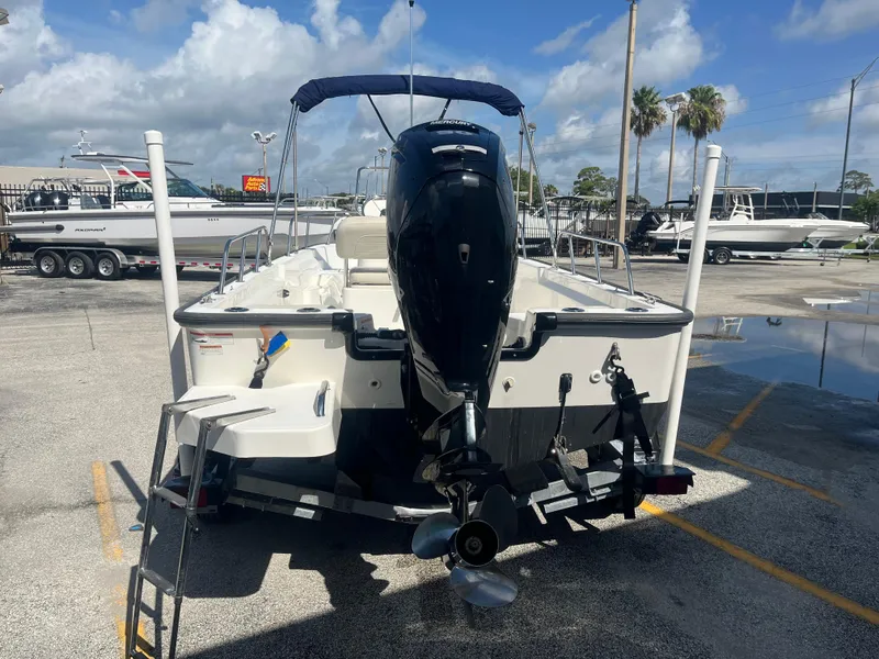 Slide: The Image of 2022 Boston Whaler 170 Montauk boat with outboard motor, parked in a marina. - 5