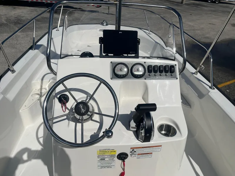 Slide: The Image of 2022 Boston Whaler 170 Montauk boat console with steering wheel and gauges. - 8