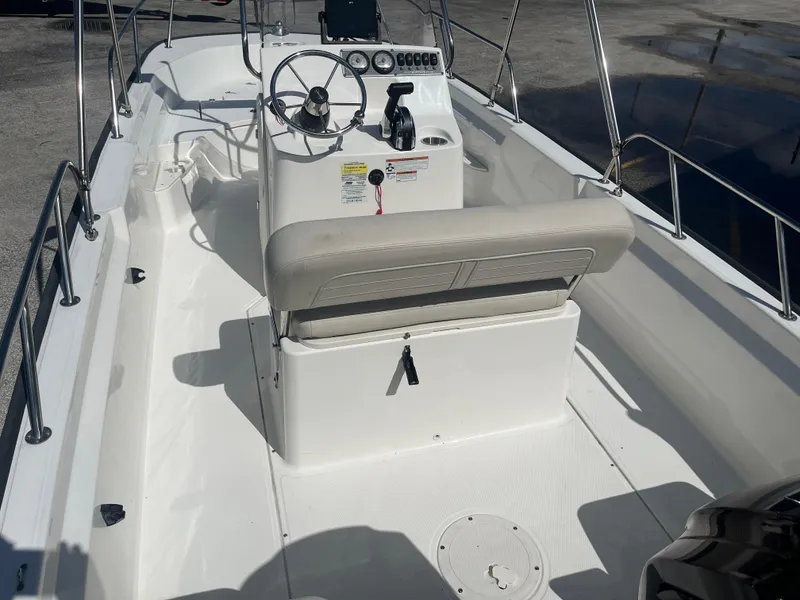 Slide: The Image of 2022 Boston Whaler 170 Montauk boat interior with steering console and seating. - 9
