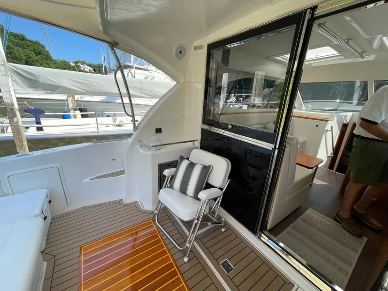 Slide: The Image of 2017 Riviera 3600 Sport Yacht interior with seating and wooden flooring. - 17