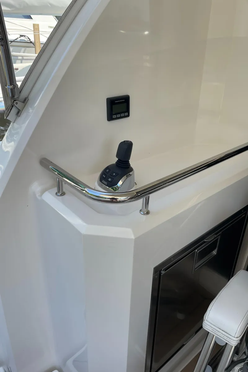 Slide: The Image of 2017 Riviera 3600 Sport Yacht interior with control panel and seating. - 19