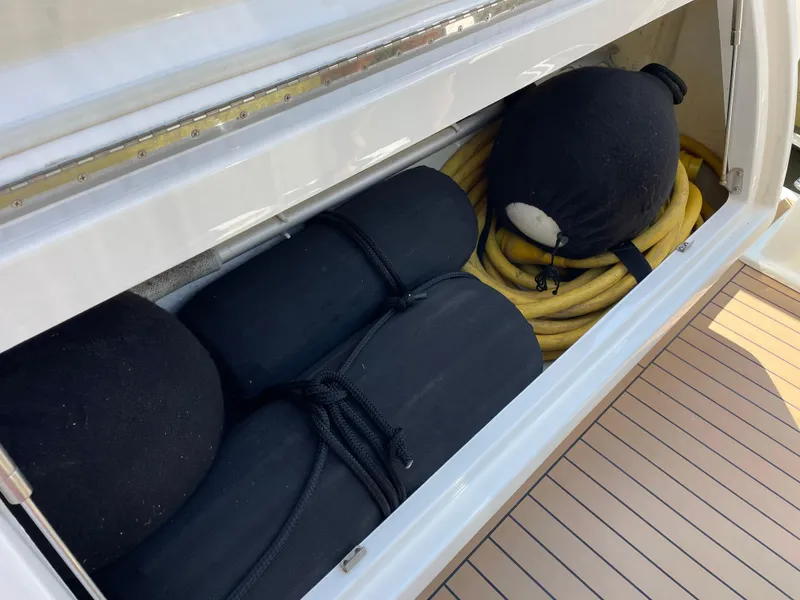 Slide: The Image of Storage compartment on 2017 Riviera 3600 Sport Yacht with fenders and coiled hose. - 23