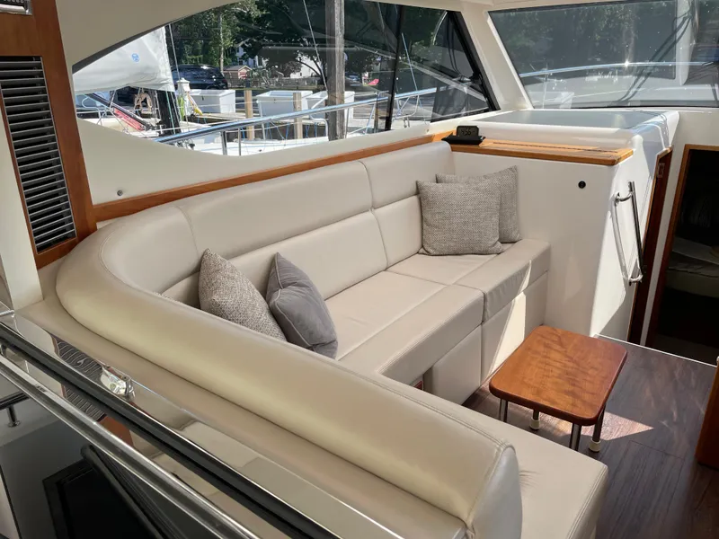 Slide: The Image of Luxurious interior of 2017 Riviera 3600 Sport Yacht with plush seating and wooden accents. - 26