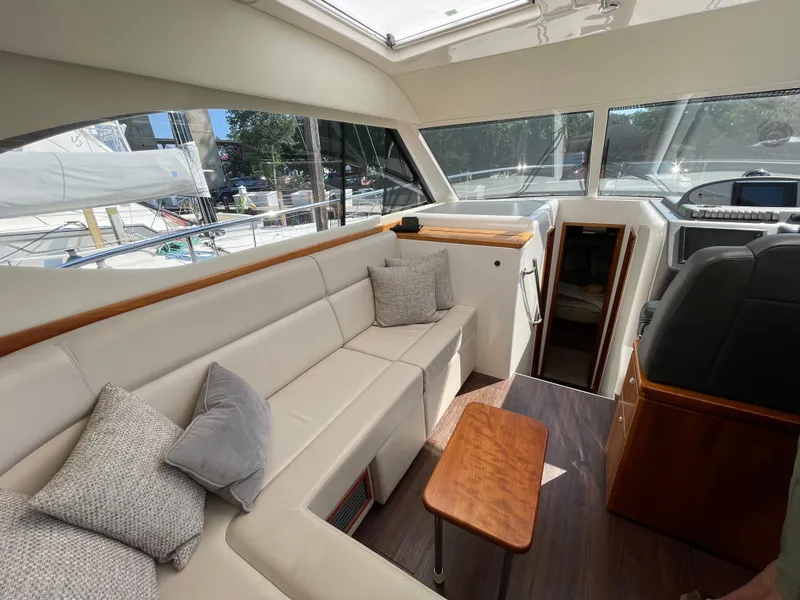 Slide: The Image of Interior of 2017 Riviera 3600 Sport Yacht with plush seating and wooden accents. - 28