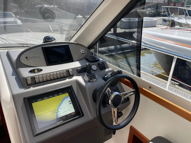 Slide: The Image of Helm of 2017 Riviera 3600 Sport Yacht with navigation system and steering wheel. - 32