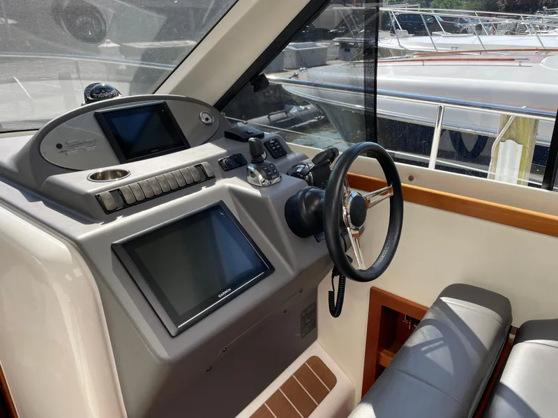 Slide: The Image of 2017 Riviera 3600 Sport Yacht helm with modern controls and navigation screens. - 33