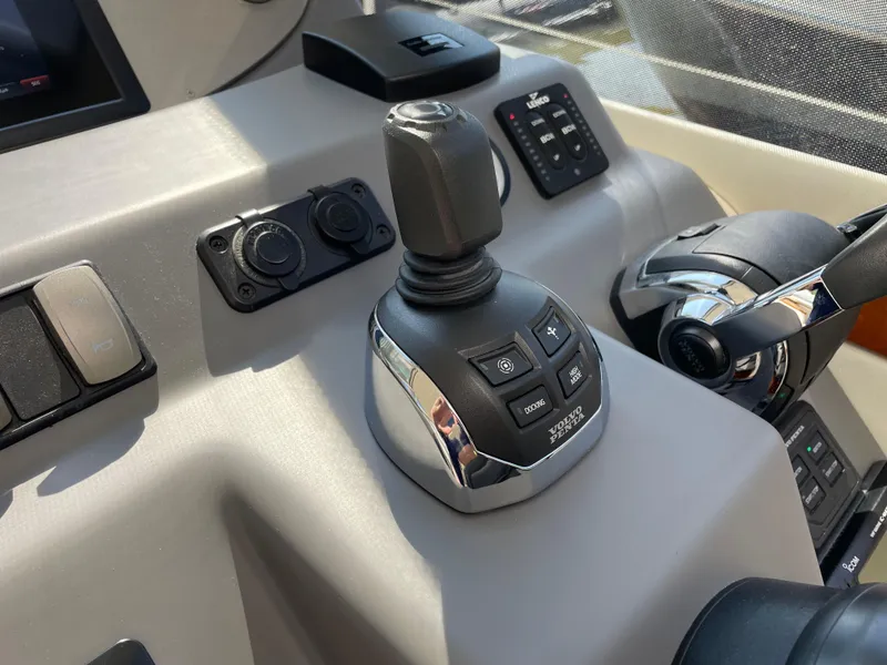 Slide: The Image of Control panel of a 2017 Riviera 3600 Sport Yacht with joystick and throttle. - 35
