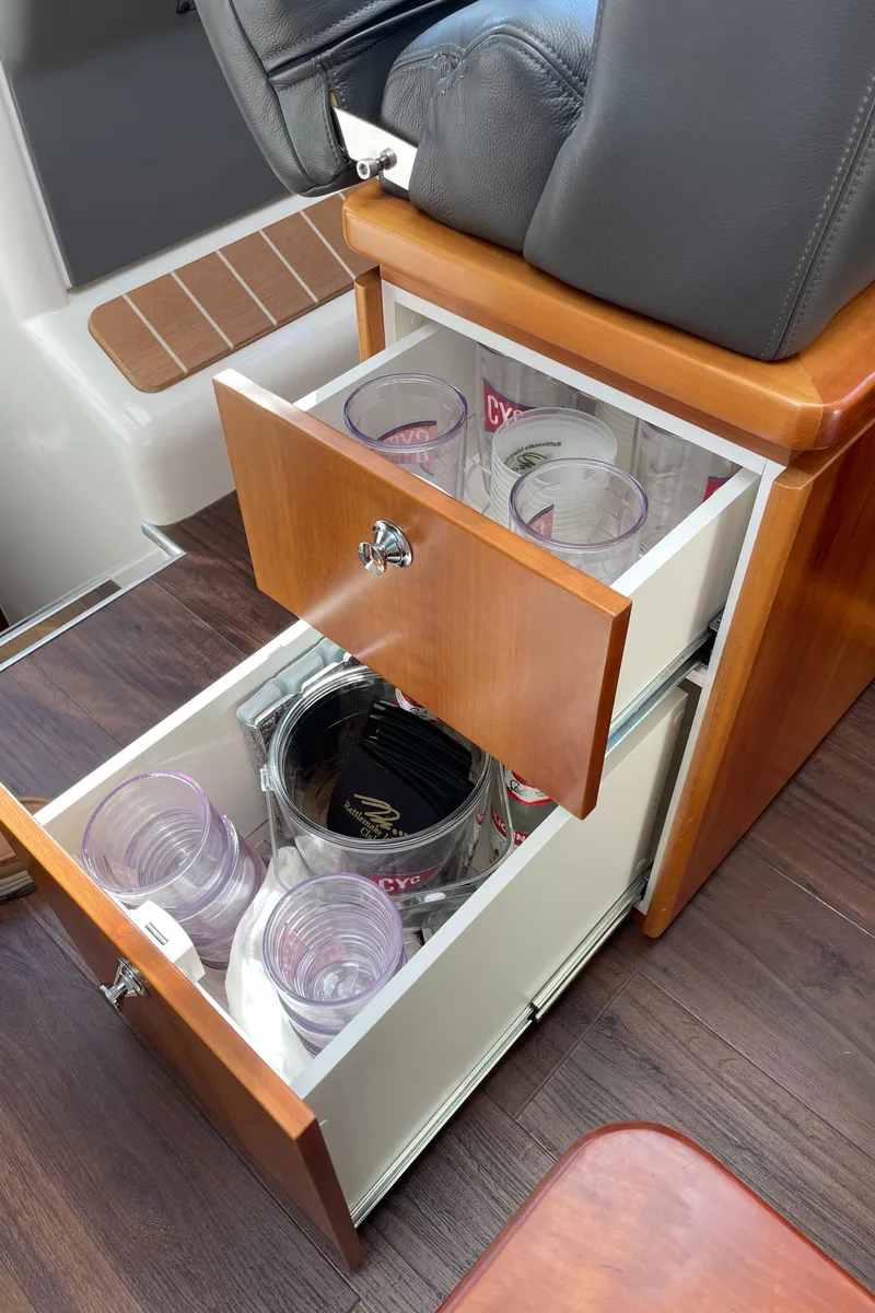 Slide: The Image of Open drawers with cups inside a 2017 Riviera 3600 Sport Yacht interior. - 36