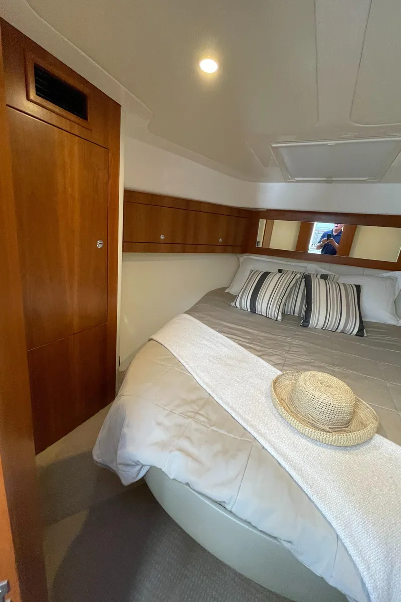 Slide: The Image of Luxurious cabin interior of 2017 Riviera 3600 Sport Yacht with cozy bed and elegant wood finish. - 38